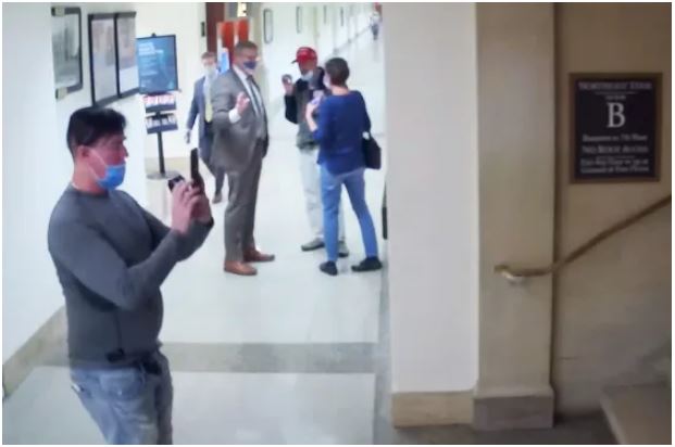 Man taking photos of staircases before Jan 6.JPG